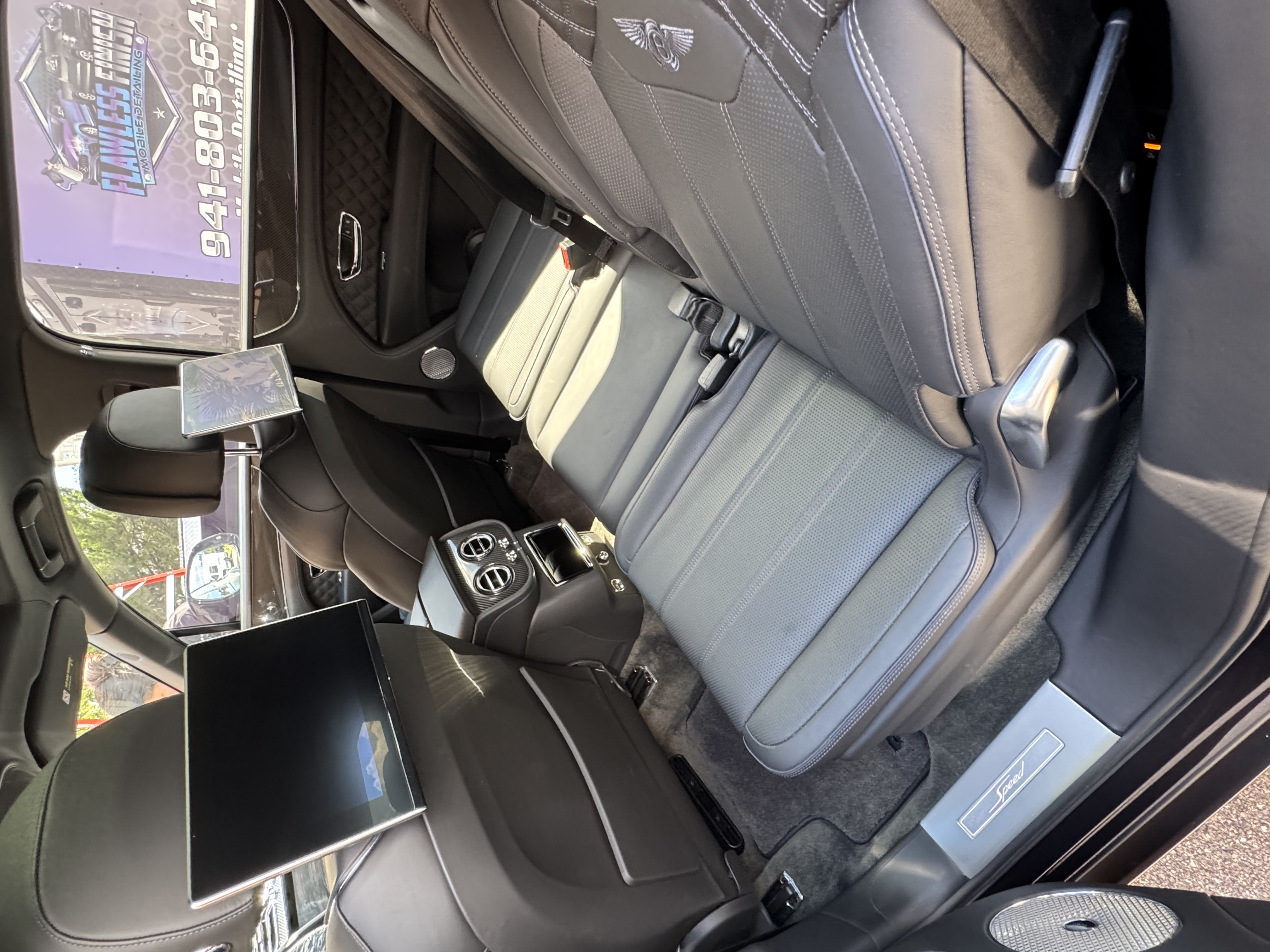 Bentley luxury interior detailing - pristine leather seats and entertainment system