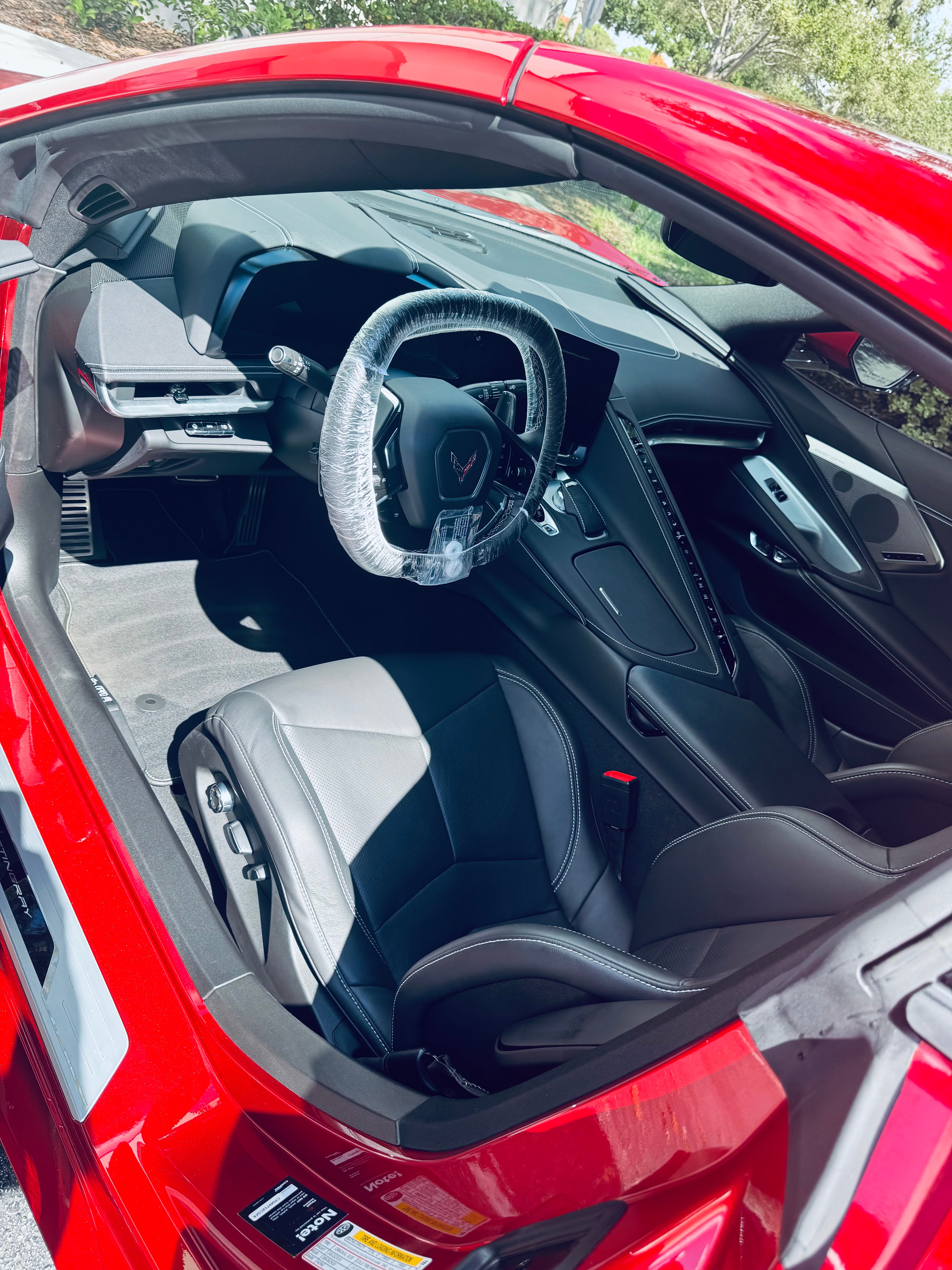 Red Corvette C8 interior detailing - pristine white and black leather seats